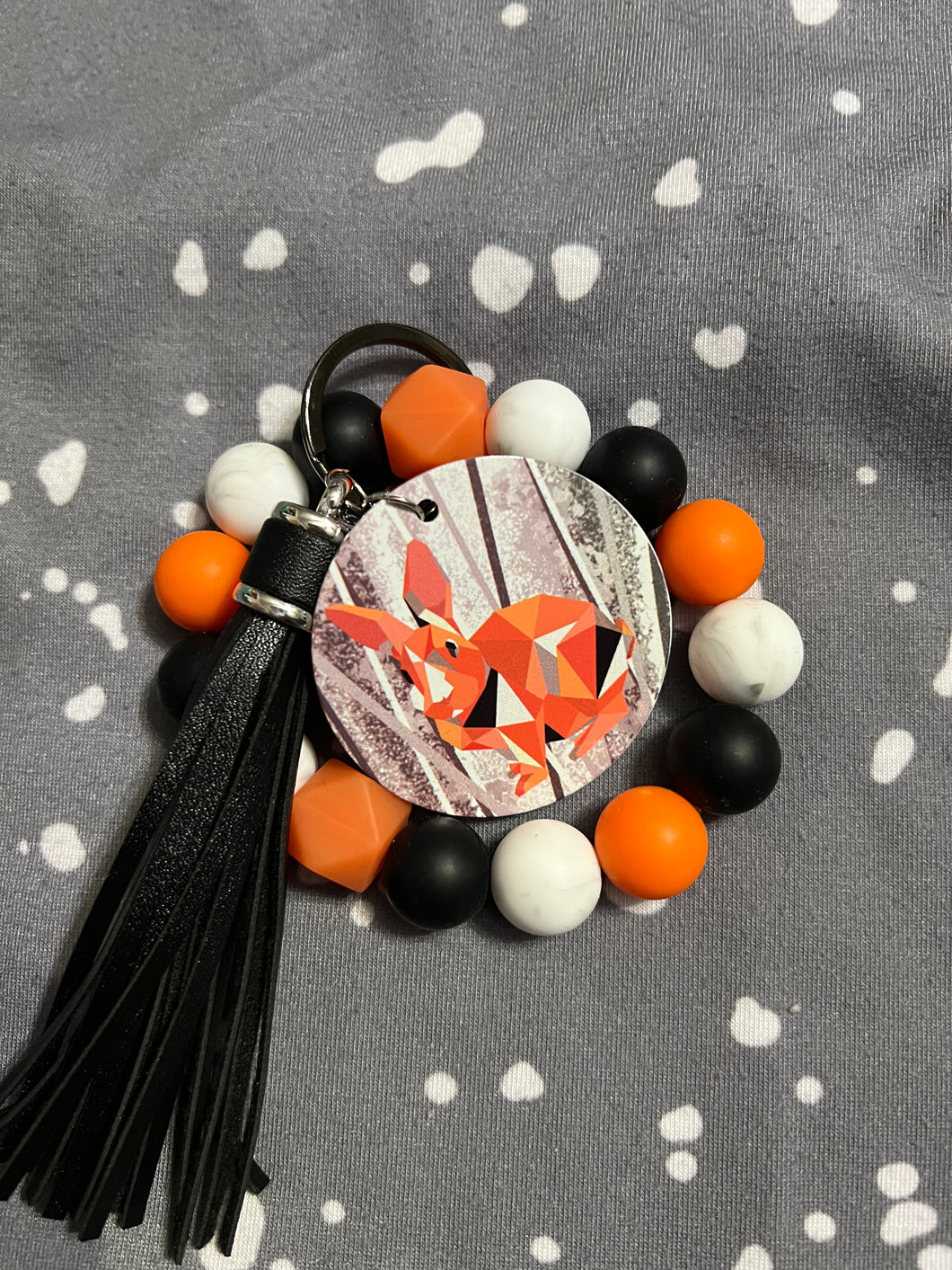 Fisher Orange, Black, and White Wristlet